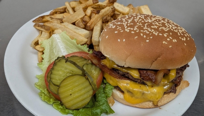 Cheeseburger with pickles, lettuce, and tomato from JC's Country Diner Restaurant Elwood Utah.