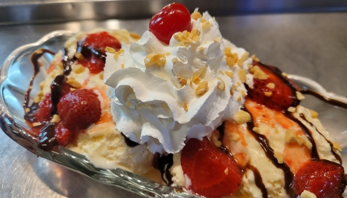 Banana split at JC's Country Diner Restaurant Elwood Utah with whipped cream and chocolate drizzle.