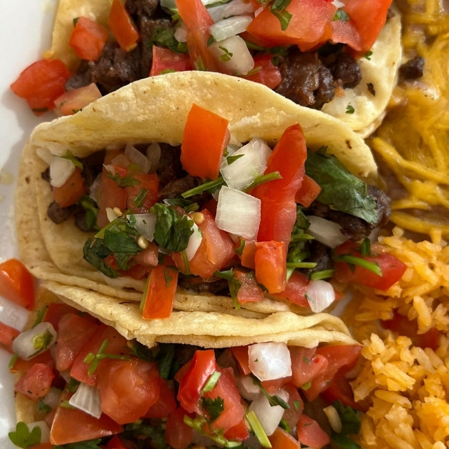 Three tacos with beef, fresh toppings, rice and beans at JC's Country Diner Restaurant Elwood Utah.