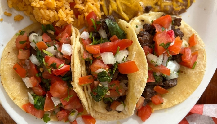 Three beef tacos with pico de gallo, rice, and beans at JC's Country Diner Restaurant Elwood Utah.