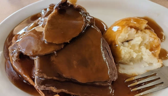 Sliced roast beef with brown gravy and mashed potatoes at JC's Country Diner Restaurant Elwood Utah.