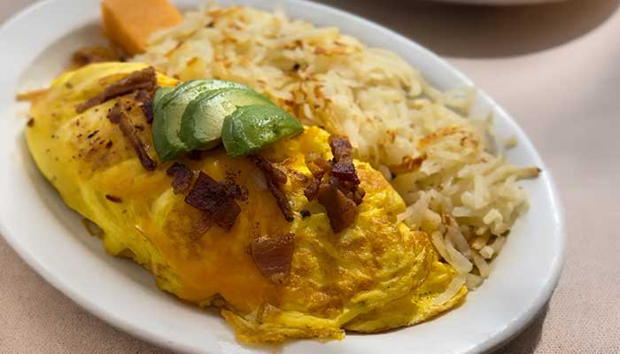 Cheese omelet topped with bacon and avocado at JC's Country Diner Restaurant Elwood Utah.