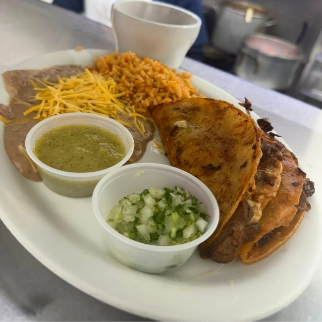 Plate at JC's Country Diner Restaurant Elwood Utah with quesabirria taco, beans, rice, and salsa verde.